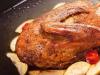 Christmas duck with apples and oranges in the oven